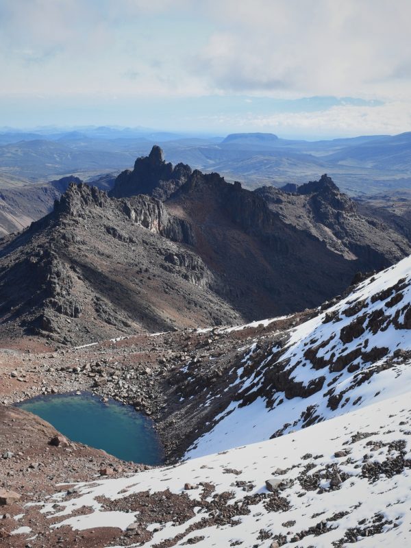 Scenic view of Lake Michaelson resting under the point of the mount Kenya partially covered by snow