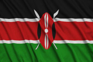 Kenya flag is depicted on a sports cloth fabric with many folds. Sport team waving banner